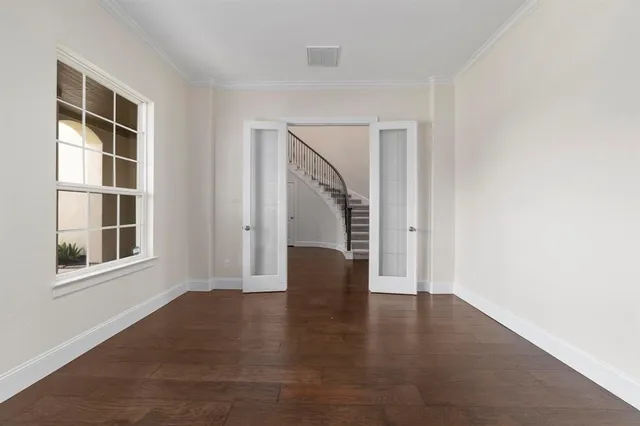 an empty room with windows and entryway