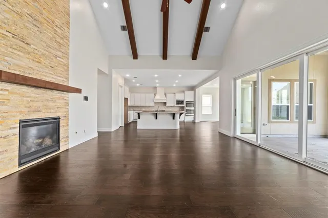 a view of a livingroom with wooden floor and a fireplace