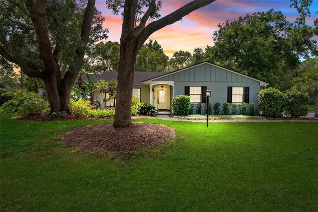 a front view of house with yard and green space