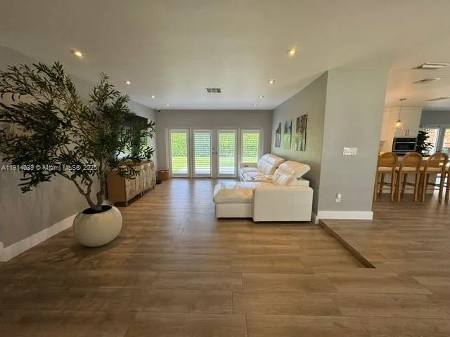 a spacious bedroom with a large bed and a chandelier