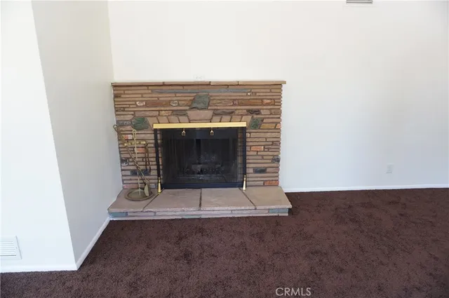 a kitchen with stainless steel appliances granite countertop a refrigerator a sink dishwasher a stove and white countertops with wooden floor