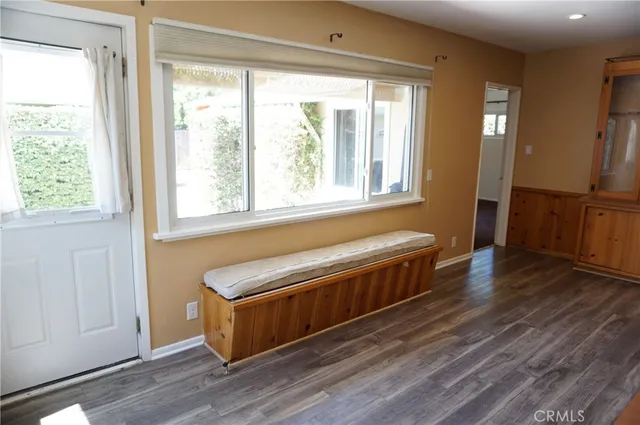 a view of workspace with wooden floor and furniture window