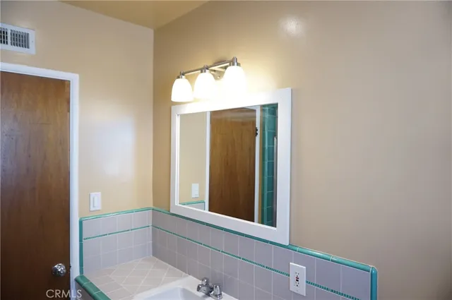 a view of a patio with chairs and potted plants