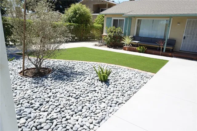an empty room with windows and fireplace
