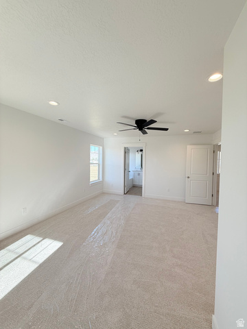 1142 West 220 North Mapleton, UT 84664 - Photo 13 of 26 Unfurnished room with light colored carpet, ceiling fan, recessed lighting, and a textured ceiling