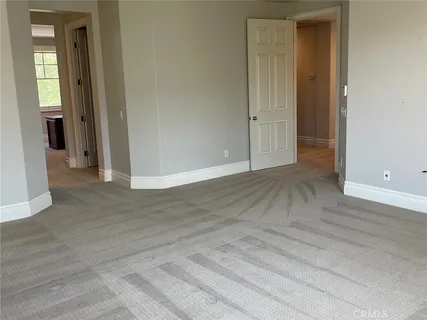 a large white kitchen with sink a large window and a counter top space