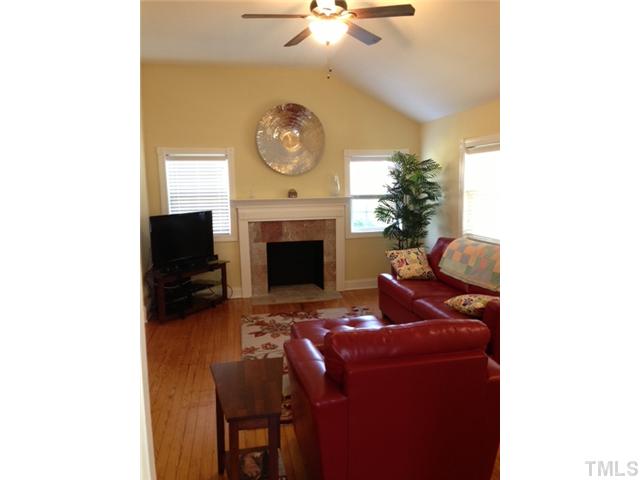 2310 Wade Avenue Raleigh, NC 27607 - Photo 2 of 14 a living room with furniture and a fireplace