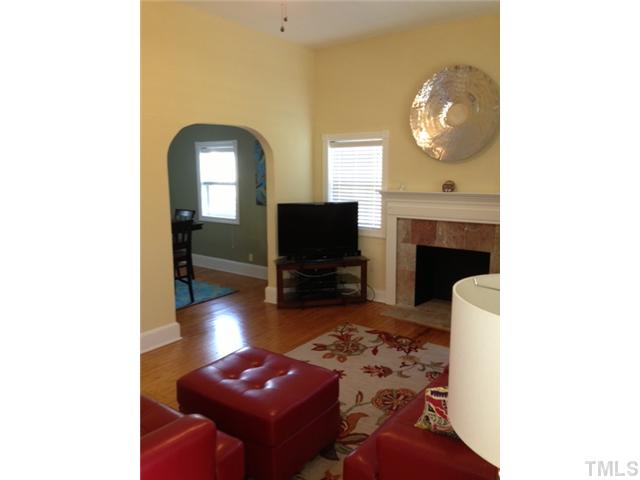 2310 Wade Avenue Raleigh, NC 27607 - Photo 4 of 14 a living room with furniture and a fireplace