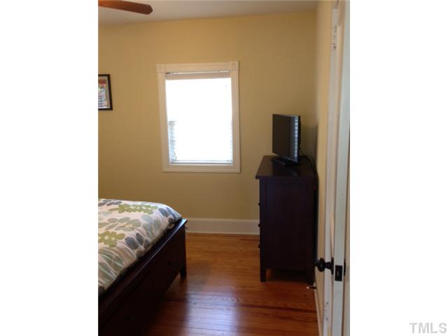 2310 Wade Avenue Raleigh, NC 27607 - Photo 9 of 14 a room with a window and wooden floor