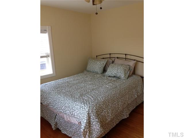 2310 Wade Avenue Raleigh, NC 27607 - Photo 10 of 14 a bedroom with a bed and a window
