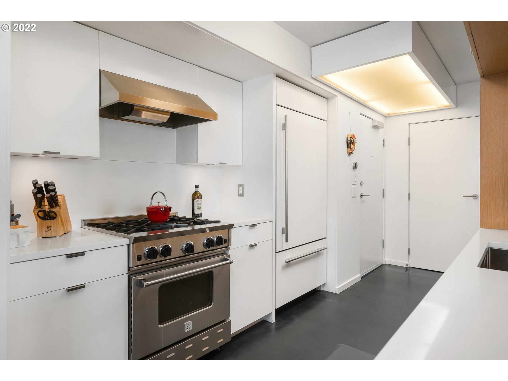1500 Southwest 11th Avenue, Unit 1504 Portland, OR 97201 - Photo 18 of 32 a kitchen with stainless steel appliances a stove and a refrigerator