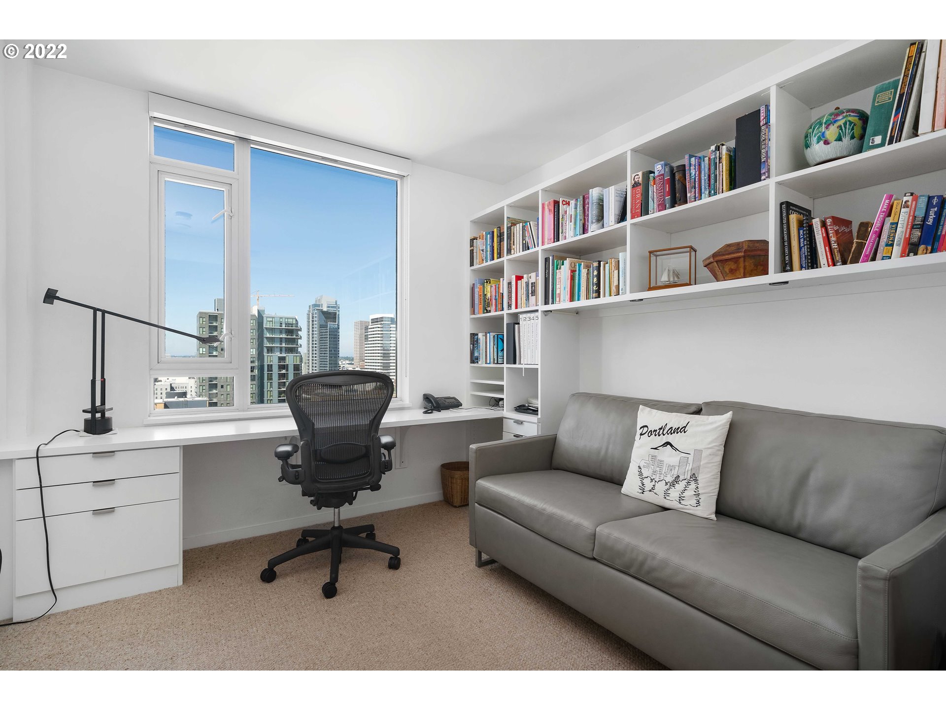1500 Southwest 11th Avenue, Unit 1504 Portland, OR 97201 - Photo 29 of 32 a living room with furniture and a book shelf