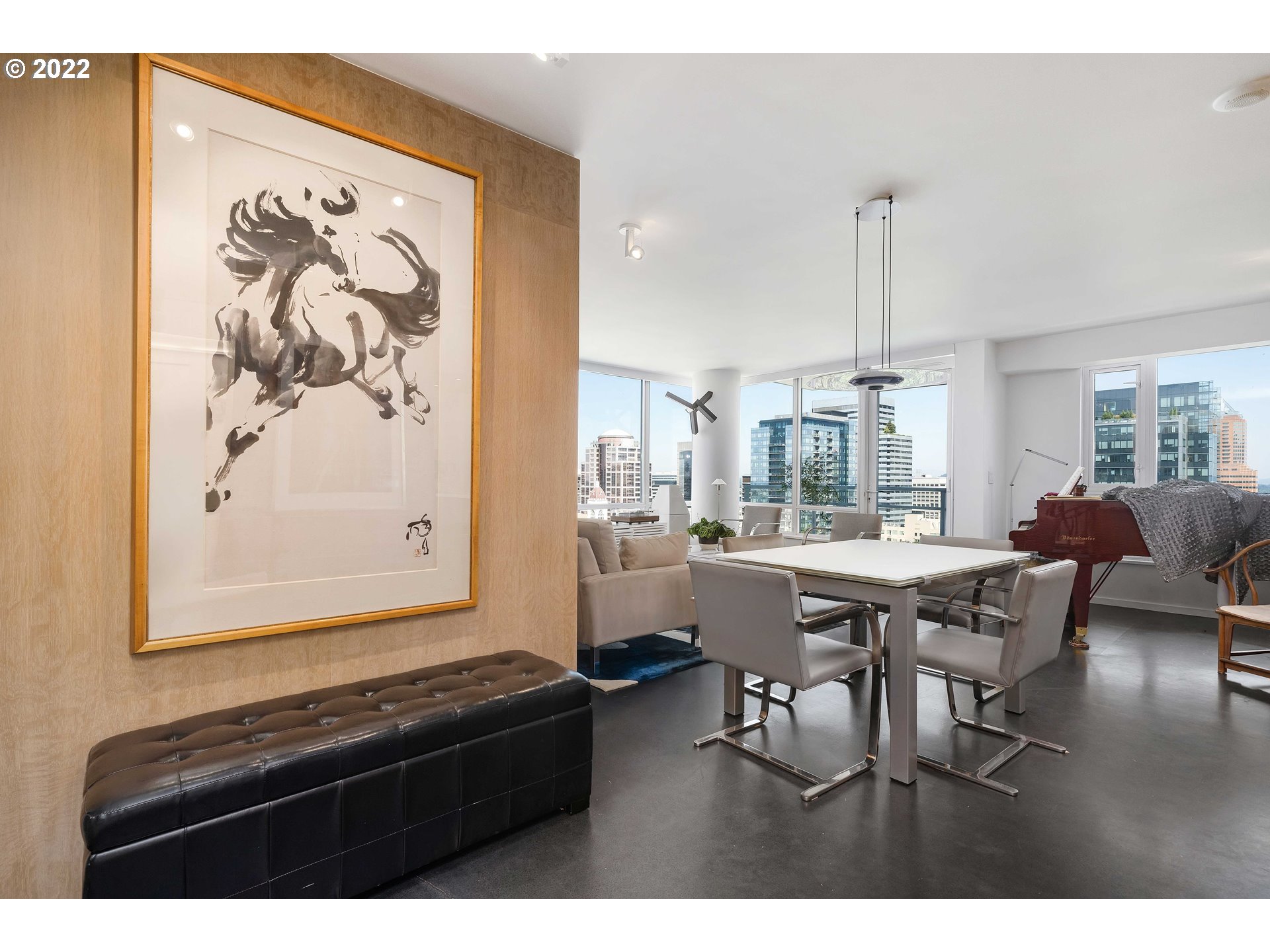 1500 Southwest 11th Avenue, Unit 1504 Portland, OR 97201 - Photo 9 of 32 a living room with a table chairs and a painting on the wall