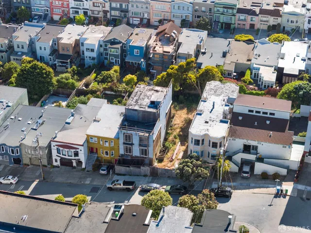 an aerial view of houses with outdoor space