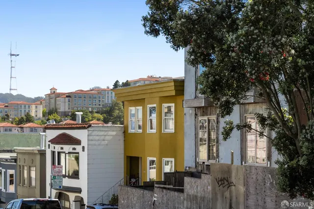 a front view of a residential apartment building with a yard