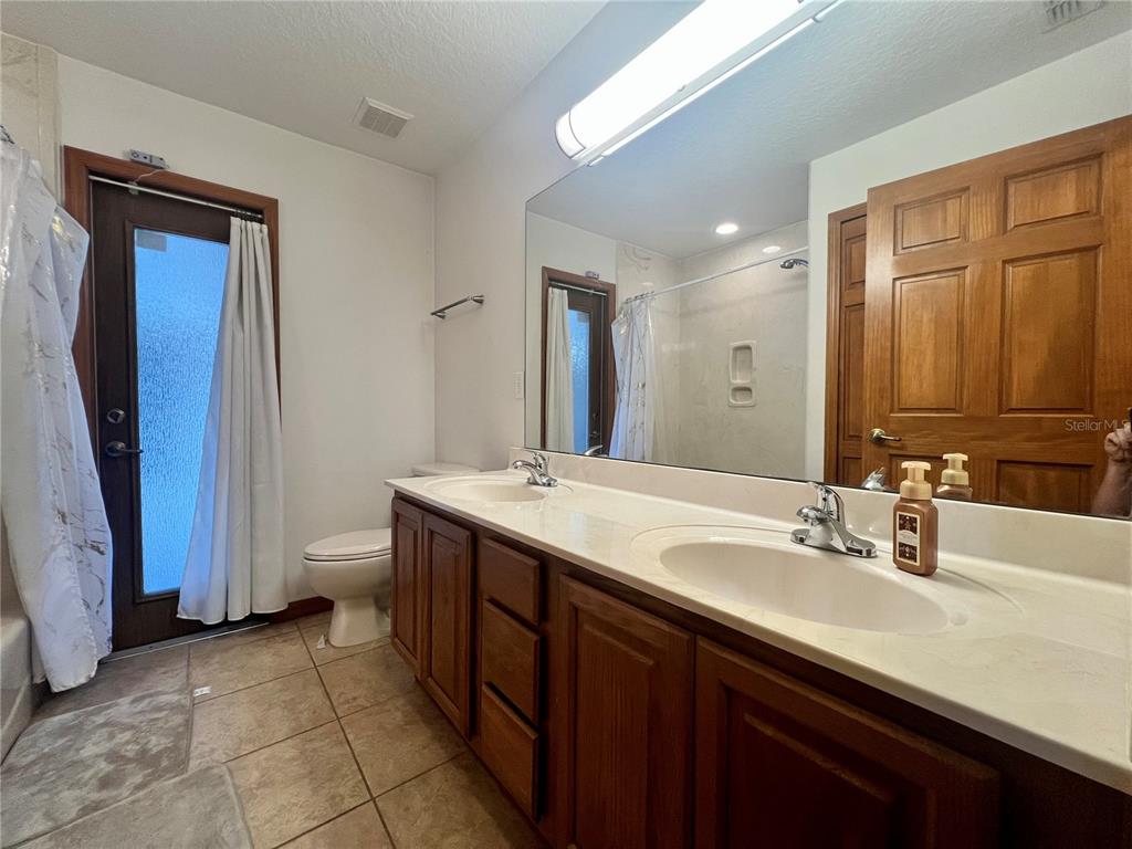 1156 South Carpenter Avenue Orange City, FL 32763 - Photo 17 of 21 a bathroom with a sink and a mirror