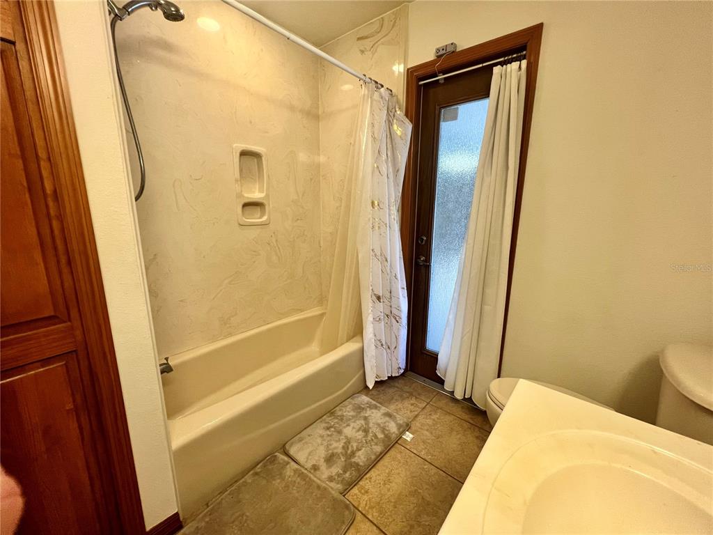 1156 South Carpenter Avenue Orange City, FL 32763 - Photo 18 of 21 a bathroom with a tub and a shower
