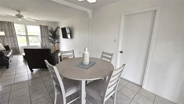 a view of a dining room with furniture and window
