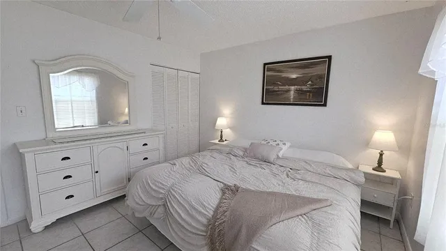 a bedroom with a bed and a mirror