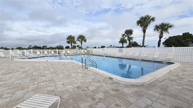 a view of swimming pool with outdoor seating