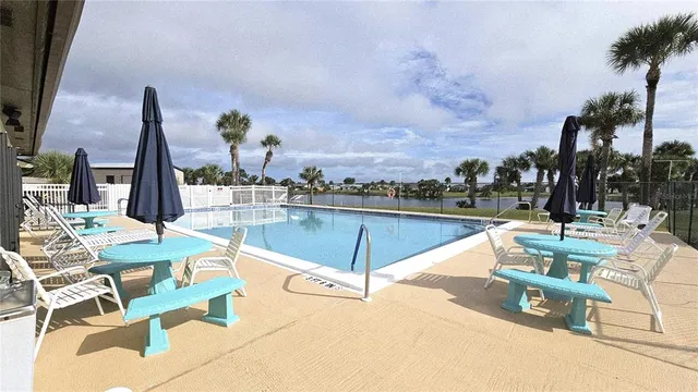 a view of a swimming pool with outdoor seating