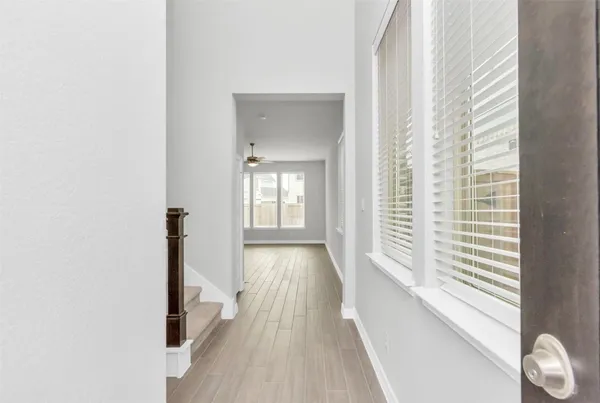 a view of a room with wooden floor and window