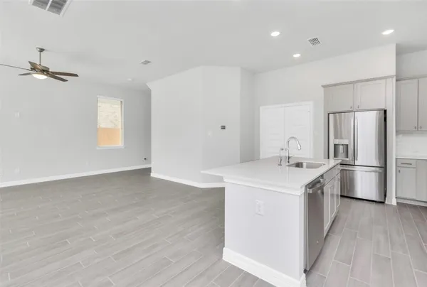 a kitchen with a sink a refrigerator and window