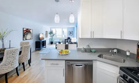 a kitchen with a sink a stove and cabinets