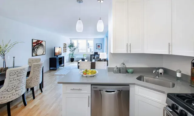 a kitchen with a sink a stove and cabinets