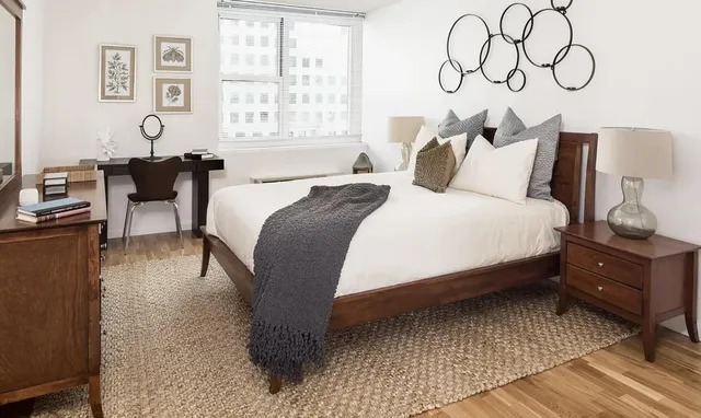 a bedroom with a bed and wooden floor