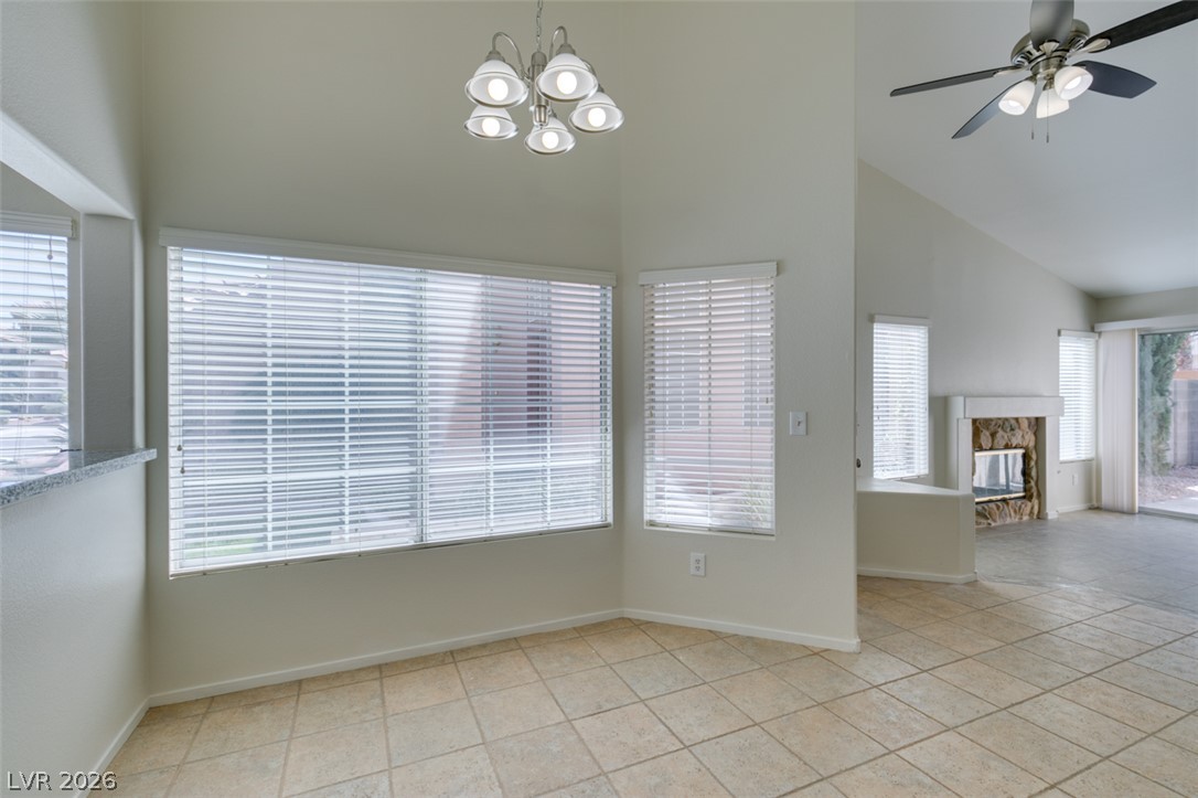 307 Cavalla Street Henderson, NV 89074 - Photo 18 of 44 A spacious room offers vaulted ceilings, abundant natural light, and a cozy fireplace.