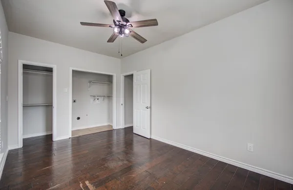a view of a living room with wooden floor and stairs