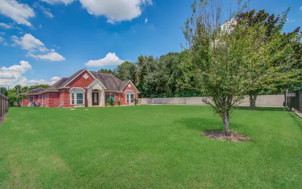 a view of a hallway with wooden floor and front door