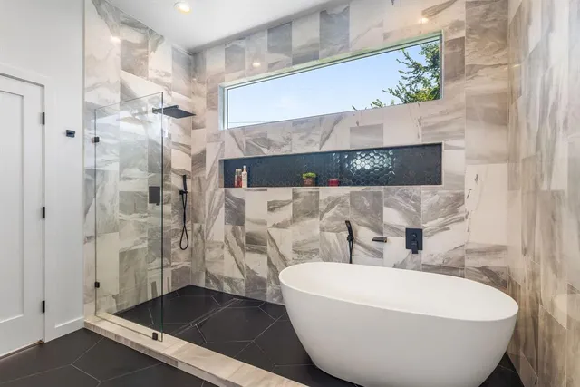 a bathroom with a bathtub and shower