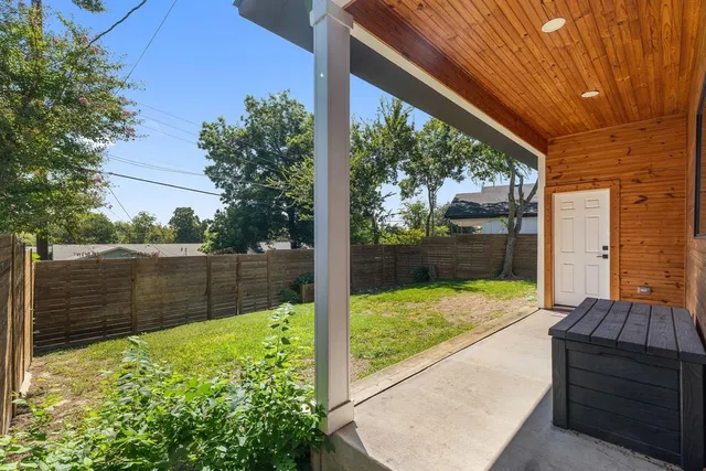 a view of backyard with wooden fence and floor