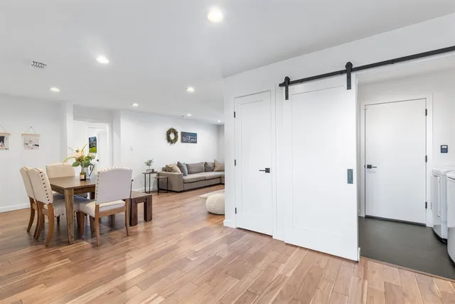 a view of a dining room with furniture and wooden floor