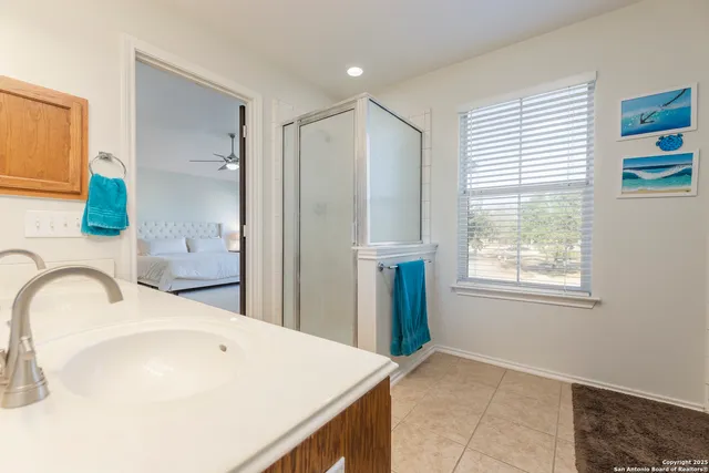 a bathroom with a sink a vanity and a window
