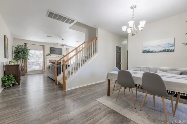 a view of a dining room with furniture wooden floor and chandelier