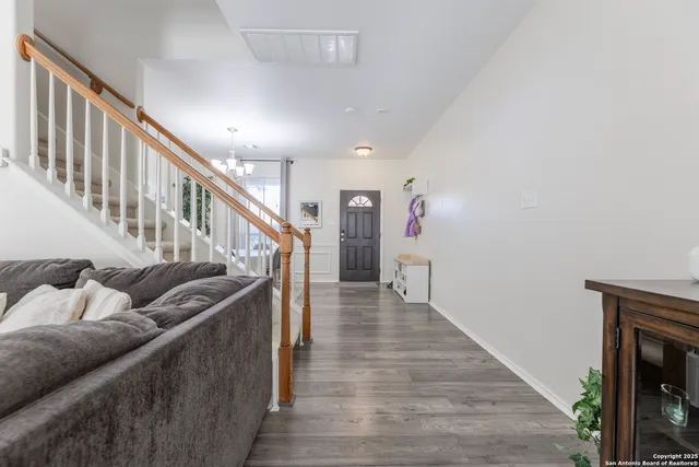 a living room with furniture and stairs