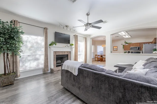 a living room with furniture a flat screen tv and a fireplace