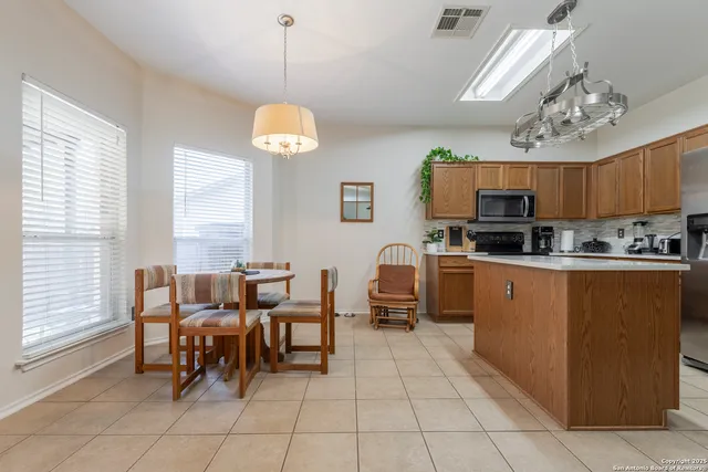 a kitchen with stainless steel appliances granite countertop a sink counter top space and a window