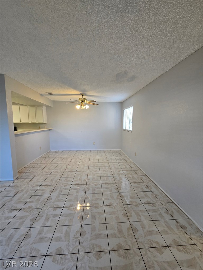 6750 Del Rey Avenue, Unit 133 Las Vegas, NV 89146 - Photo 8 of 34 A versatile living space with patterned tile flooring and an integrated kitchen counter.