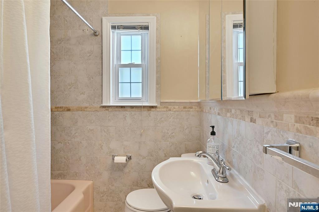 85 Edison Street Clifton, NJ 07013 - Photo 12 of 28 a bathroom with a sink and a bathtub