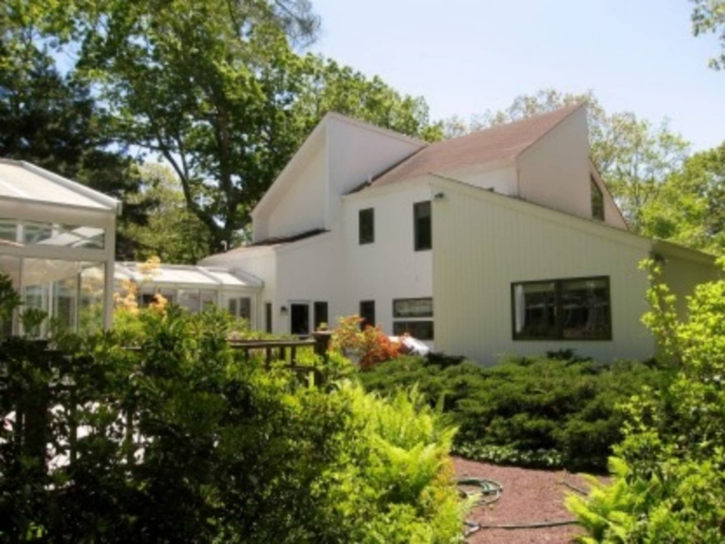 120 Springy Banks Road East Hampton, NY 11937 - Photo 10 of 10 a view of a white house with a yard and potted plants