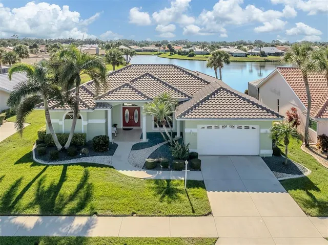 a view of a house with swimming pool and a yard