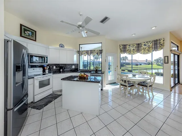 a kitchen with white cabinets appliances and sink