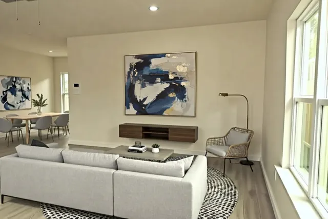 a living room with furniture a rug and a large window