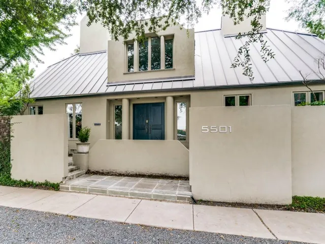 a view of a white house with a outdoor space