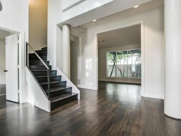 a view of an entryway with wooden floor and staircase