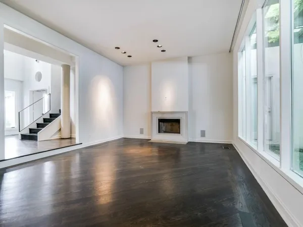 a view of an empty room with glass door and a window